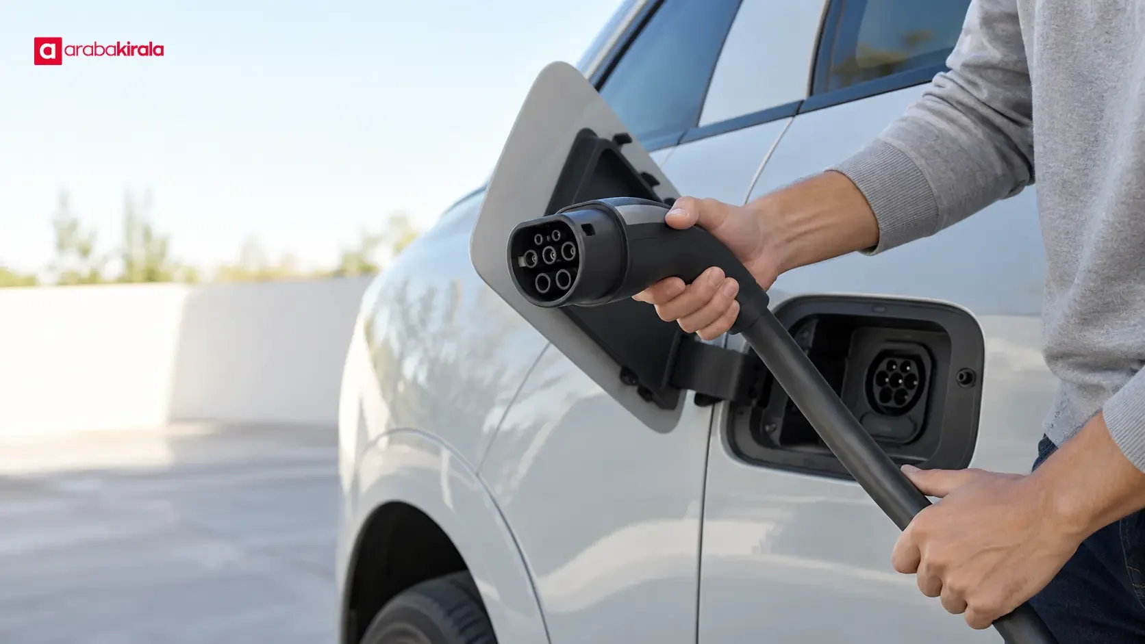 Charging cable connector beside an electric car’s charging inlet